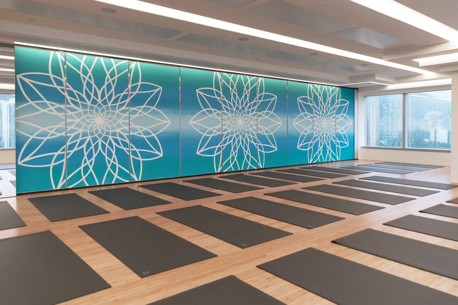 apm: Yoga mats beside a blue floral feature wall.