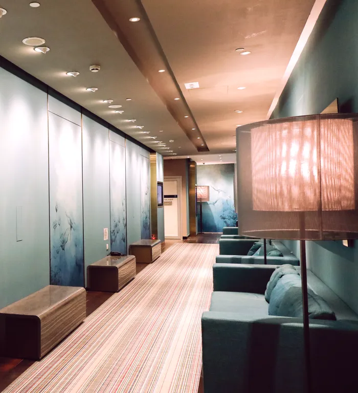 Langham Place Yoga: Club lounge with upholstered seating and decorative panels.
