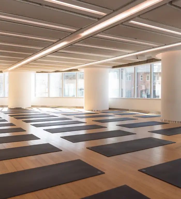 Langham Place Yoga: Bright yoga studio with floor mats and large windows.